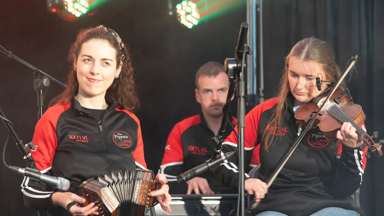 Trad musicians playing accordion and fiddle on stage
