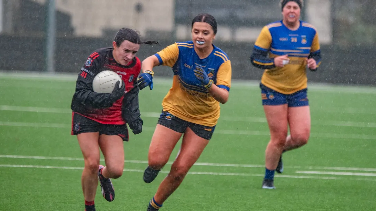 Ladies player in red and black breaking away from two players in blue and gold