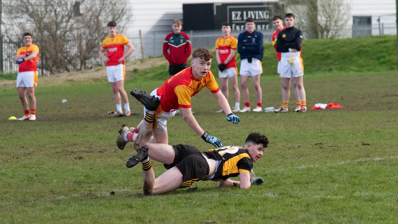Castlebar Mitchels player tackling a player in black and amber to the ground