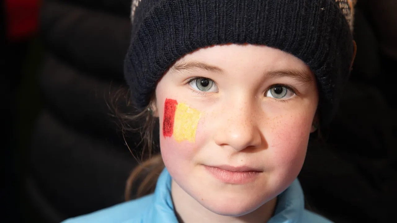 Child with red and gold face paint