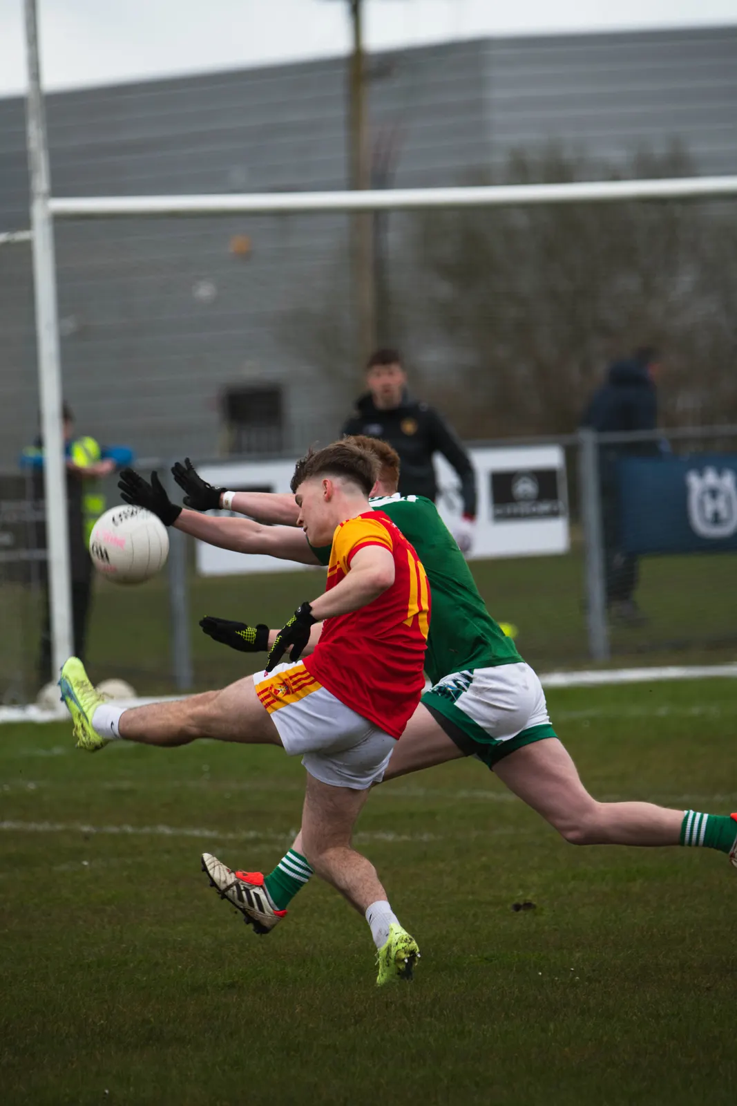 Castlebar Mitchels player shooting under pressure from a defender in green